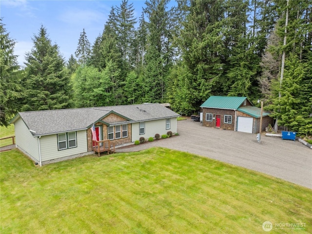 132 River Park Rd, Forks, WA 98331 - view of front of home featuring an outdoor structure, a front lawn, and a garage