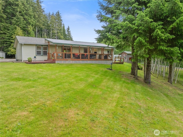 132 River Park Rd, Forks, WA 98331 - back of property with a wooden deck and a lawn