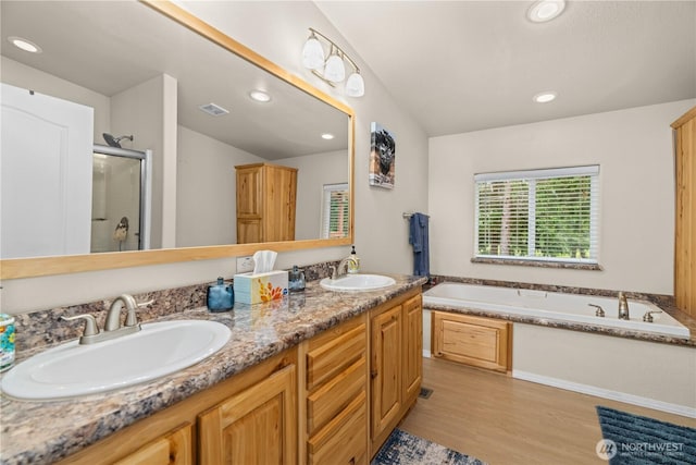 132 River Park Rd, Forks, WA 98331 - bathroom with a stall shower, a garden tub, wood finished floors, double vanity, and recessed lighting