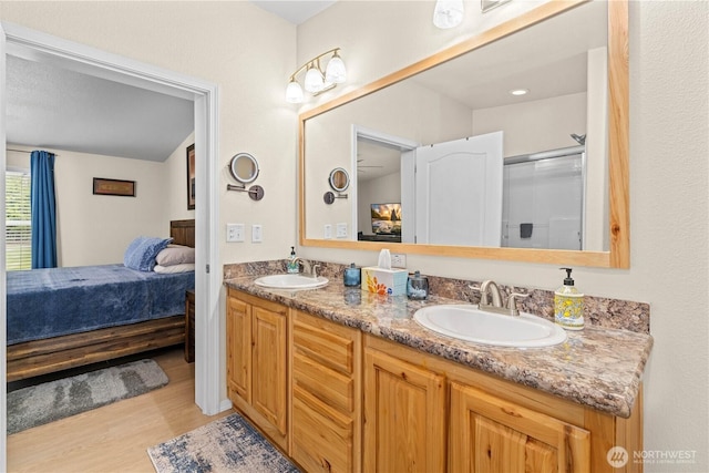 132 River Park Rd, Forks, WA 98331 - bathroom featuring ensuite bath, wood finished floors, double vanity, and a shower with shower door