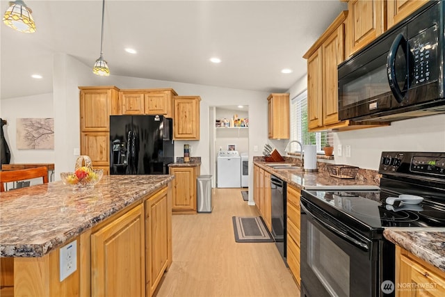 132 River Park Rd, Forks, WA 98331 - kitchen with black appliances, a sink, separate washer and dryer, light wood-style flooring, and stone countertops