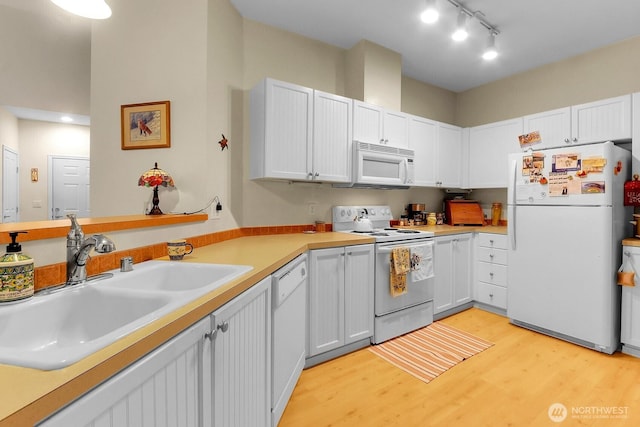 1500 S 18th St Unit F202, Renton, WA 98055 - kitchen with white appliances, light wood-style floors, white cabinets, and light countertops