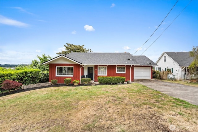 261 SE Adams Ave, Chehalis, WA 98532 - single story home with an attached garage, asphalt driveway, a front yard, and board and batten siding