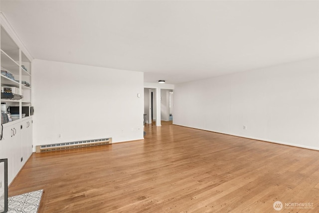 261 SE Adams Ave, Chehalis, WA 98532 - empty room featuring a baseboard heating unit and light wood finished floors