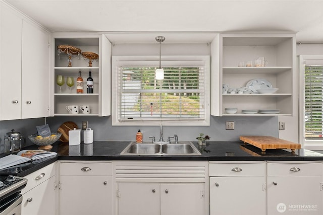 261 SE Adams Ave, Chehalis, WA 98532 - kitchen with open shelves, a sink, white cabinets, dark countertops, and stainless steel range oven