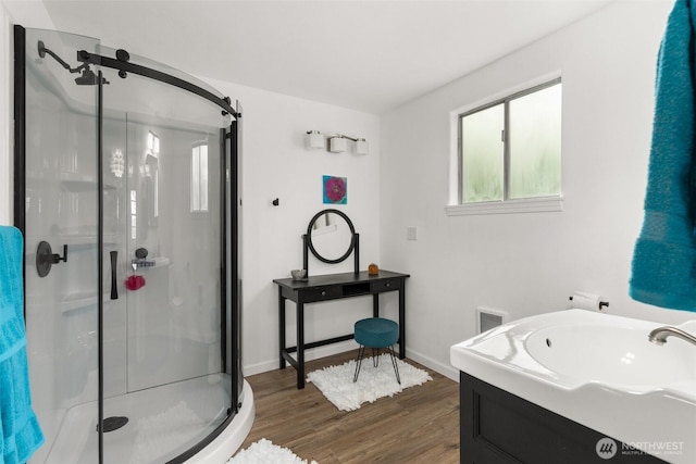 261 SE Adams Ave, Chehalis, WA 98532 - full bathroom with a stall shower, wood finished floors, vanity, and baseboards