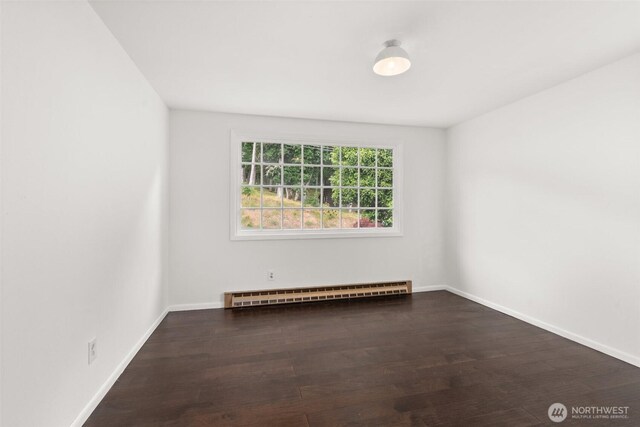 261 SE Adams Ave, Chehalis, WA 98532 - unfurnished room with baseboard heating, wood finished floors, and baseboards