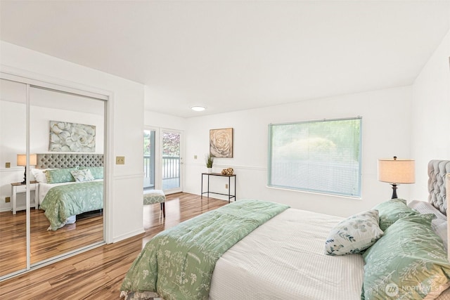 8471 E Caraway Rd, Port Orchard, WA 98366 - bedroom featuring wood finished floors, access to exterior, and a closet