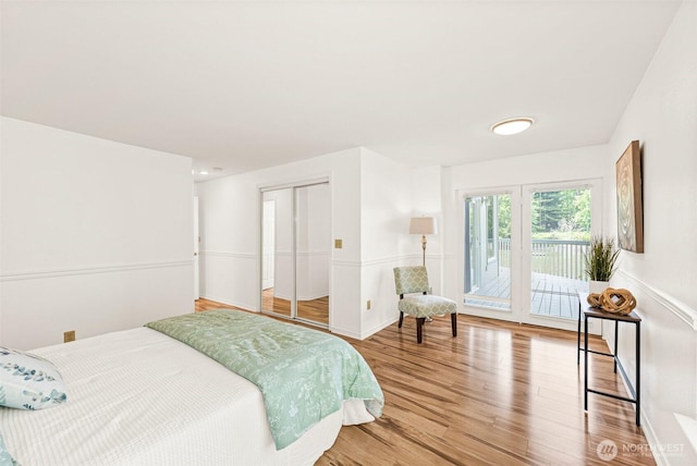 8471 E Caraway Rd, Port Orchard, WA 98366 - bedroom with access to exterior, light wood-type flooring, and a closet