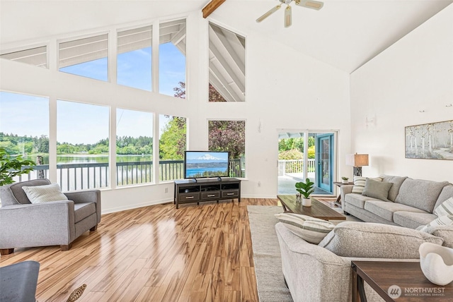 8471 E Caraway Rd, Port Orchard, WA 98366 - living room with high vaulted ceiling, beamed ceiling, ceiling fan, wood finished floors, and baseboards