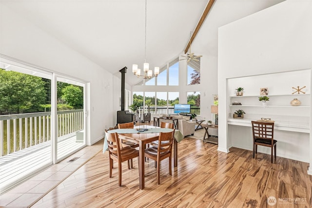 8471 E Caraway Rd, Port Orchard, WA 98366 - dining area with healthy amount of natural light, light wood-style flooring, high vaulted ceiling, a chandelier, and beam ceiling