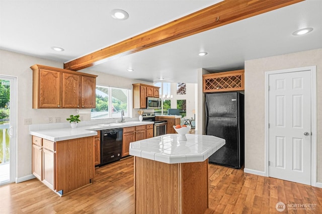8471 E Caraway Rd, Port Orchard, WA 98366 - kitchen featuring black appliances, tile countertops, light wood-style floors, a center island, and beamed ceiling