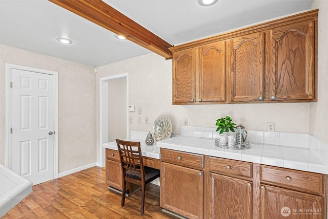 8471 E Caraway Rd, Port Orchard, WA 98366 - kitchen featuring wood finished floors, brown cabinets, recessed lighting, and tile counters