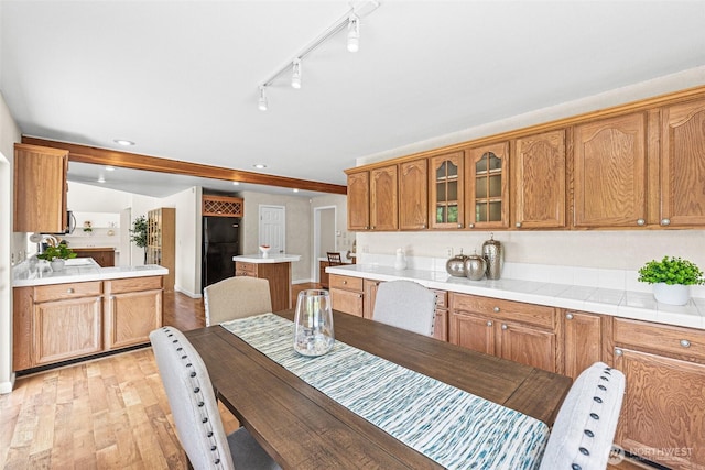 8471 E Caraway Rd, Port Orchard, WA 98366 - kitchen with glass insert cabinets, freestanding refrigerator, light wood-style floors, light countertops, and recessed lighting