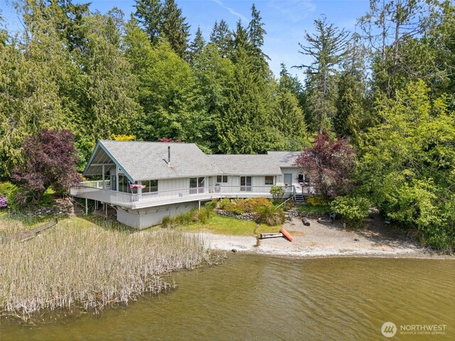 8471 E Caraway Rd, Port Orchard, WA 98366 - aerial view of property and surrounding area with a nearby body of water and a heavily wooded area