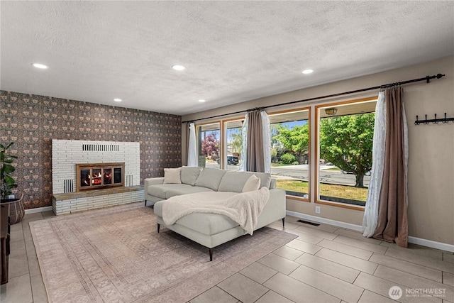 1011 Idaho St, Wenatchee, WA 98801 - living room featuring baseboards, a textured ceiling, recessed lighting, wallpapered walls, and a brick fireplace