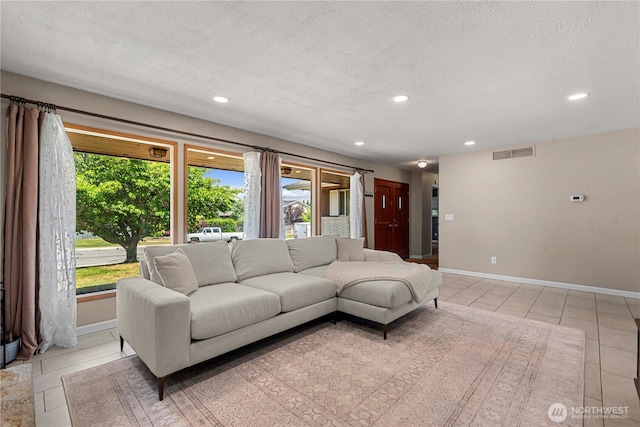 1011 Idaho St, Wenatchee, WA 98801 - living area with light tile patterned floors, recessed lighting, baseboards, and a textured ceiling