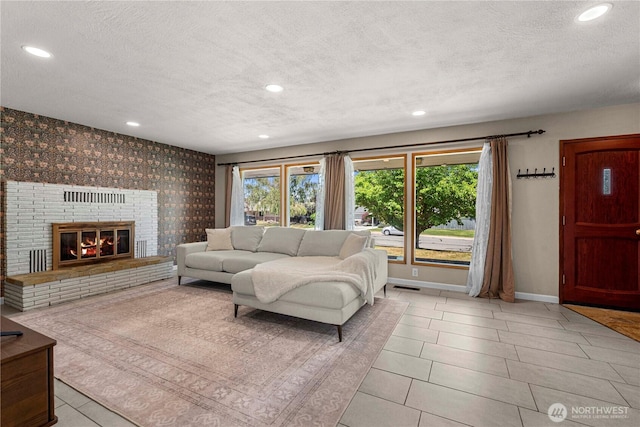 1011 Idaho St, Wenatchee, WA 98801 - living area featuring a textured ceiling, baseboards, recessed lighting, a brick fireplace, and light tile patterned floors