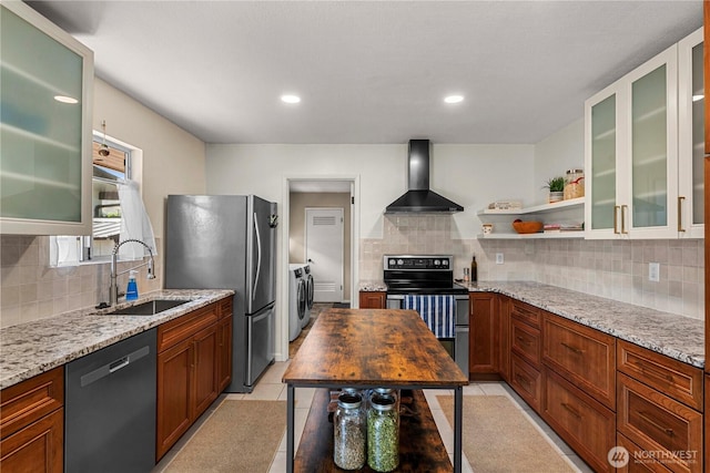 1011 Idaho St, Wenatchee, WA 98801 - kitchen with wall chimney range hood, washing machine and dryer, stainless steel appliances, a sink, and tasteful backsplash
