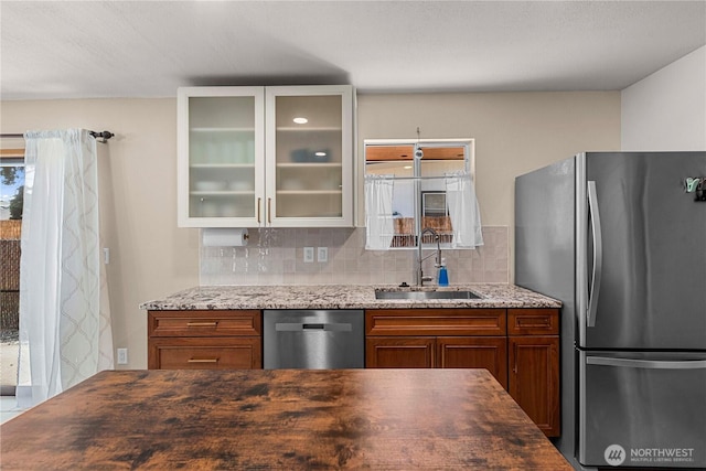 1011 Idaho St, Wenatchee, WA 98801 - kitchen with appliances with stainless steel finishes, a sink, glass insert cabinets, and tasteful backsplash