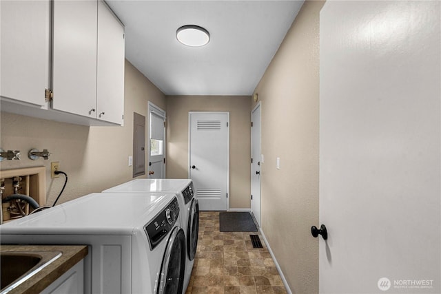 1011 Idaho St, Wenatchee, WA 98801 - laundry room featuring washer and dryer, cabinet space, stone finish floors, and baseboards