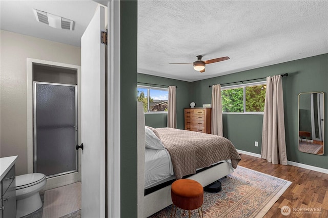 1011 Idaho St, Wenatchee, WA 98801 - bedroom featuring wood finished floors, a textured ceiling, baseboards, and a ceiling fan