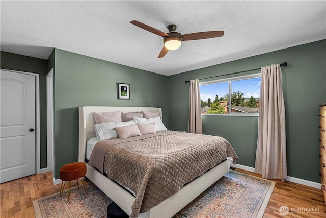 1011 Idaho St, Wenatchee, WA 98801 - bedroom with light wood-type flooring, a ceiling fan, baseboards, and a textured ceiling