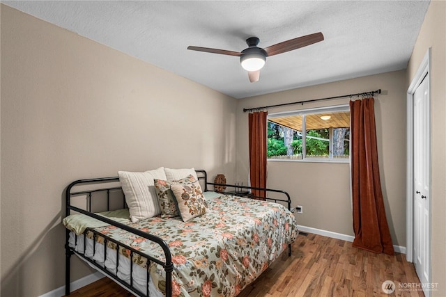 1011 Idaho St, Wenatchee, WA 98801 - bedroom featuring wood finished floors, baseboards, ceiling fan, and a closet