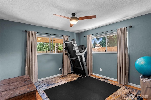 1011 Idaho St, Wenatchee, WA 98801 - exercise room with a ceiling fan, wood finished floors, baseboards, and a textured ceiling