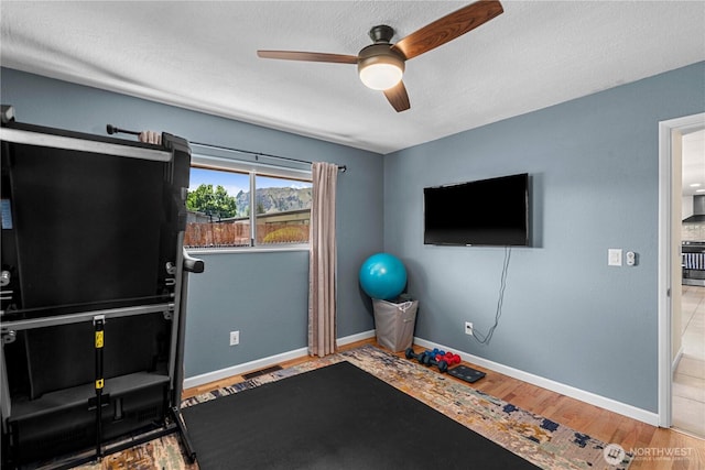 1011 Idaho St, Wenatchee, WA 98801 - exercise room with ceiling fan, baseboards, wood finished floors, and a textured ceiling