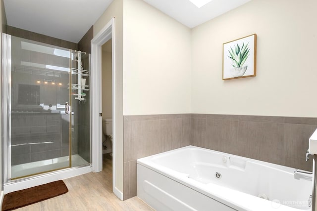 4754 SW 314th Pl, Federal Way, WA 98023 - bathroom with a whirlpool tub, a stall shower, toilet, wood finished floors, and wainscoting