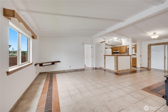 19920 67th Ave NE Unit 40, Arlington, WA 98223 - unfurnished living room with light tile patterned floors, a textured ceiling, and baseboards
