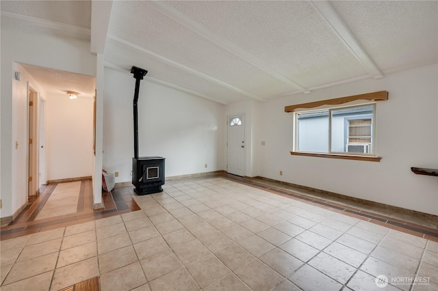 19920 67th Ave NE Unit 40, Arlington, WA 98223 - unfurnished living room with a textured ceiling, tile patterned floors, a wood stove, and beam ceiling
