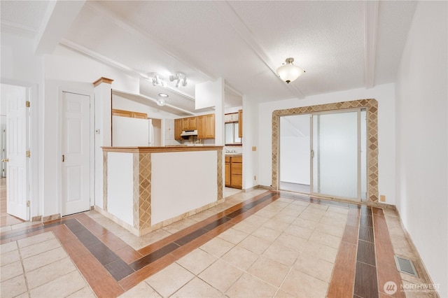 19920 67th Ave NE Unit 40, Arlington, WA 98223 - kitchen featuring freestanding refrigerator, light tile patterned floors, inlaid floor details, baseboards, and a textured ceiling
