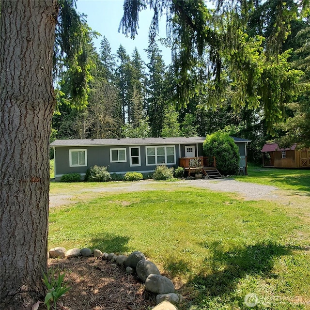 14518 Kapowsin Hwy E, Graham, WA 98338 - ranch-style home with a wooden deck and a front lawn