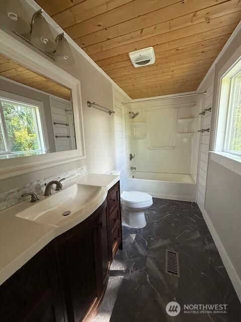 14518 Kapowsin Hwy E, Graham, WA 98338 - full bathroom with wooden ceiling, vanity, toilet, washtub / shower combination, and marble finish floors