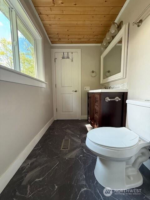 14518 Kapowsin Hwy E, Graham, WA 98338 - bathroom with wood ceiling, vanity, baseboards, toilet, and marble finish floors