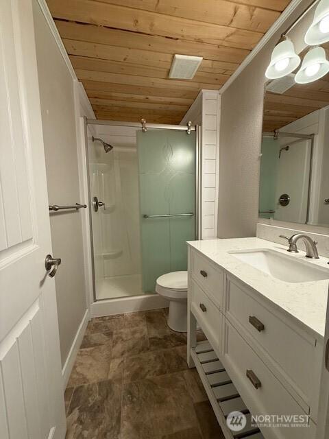 14518 Kapowsin Hwy E, Graham, WA 98338 - full bath with wood ceiling, vanity, a stall shower, toilet, and stone finish flooring