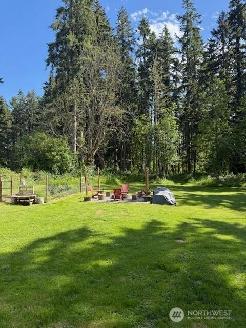 14518 Kapowsin Hwy E, Graham, WA 98338 - view of grassy yard featuring an outdoor fire pit