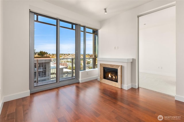 737 Olive Way Unit 2704, Seattle, WA 98101 - unfurnished living room featuring plenty of natural light, a high end fireplace, and wood finished floors