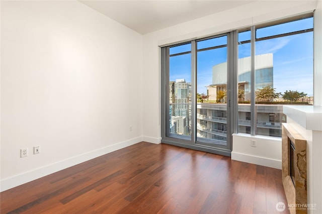 737 Olive Way Unit 2704, Seattle, WA 98101 - spare room featuring baseboards and wood finished floors
