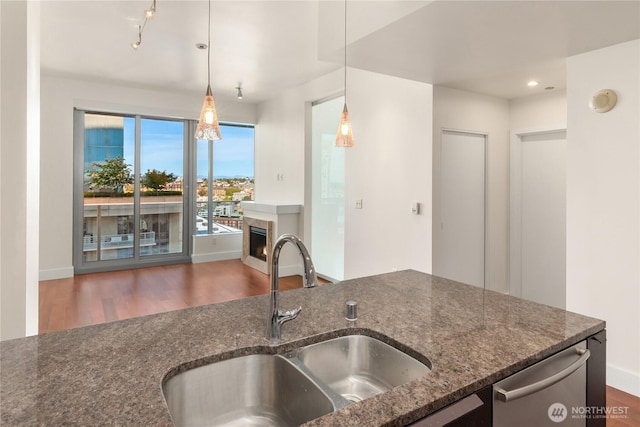 737 Olive Way Unit 2704, Seattle, WA 98101 - kitchen featuring wood finished floors, a fireplace, dark stone countertops, dishwasher, and recessed lighting