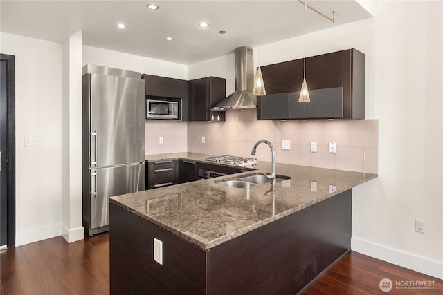 737 Olive Way Unit 2704, Seattle, WA 98101 - kitchen featuring appliances with stainless steel finishes, wall chimney range hood, a peninsula, dark wood-style flooring, and stone countertops