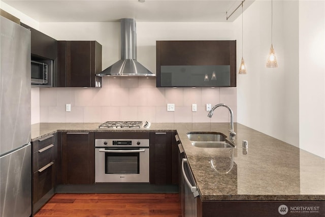 737 Olive Way Unit 2704, Seattle, WA 98101 - kitchen featuring stainless steel appliances, wall chimney range hood, a peninsula, and dark brown cabinets