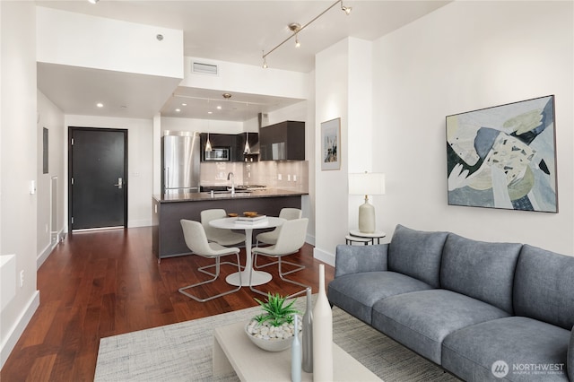 737 Olive Way Unit 2704, Seattle, WA 98101 - living area with dark wood-type flooring and track lighting