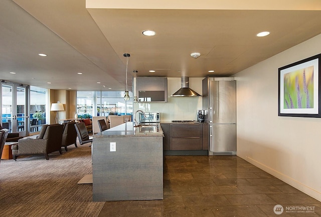 737 Olive Way Unit 2704, Seattle, WA 98101 - kitchen with wall chimney range hood, modern cabinets, recessed lighting, hanging light fixtures, and light countertops