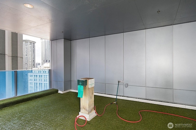 737 Olive Way Unit 2704, Seattle, WA 98101 - view of home's community featuring a putting area, a view of city, and a decorative wall