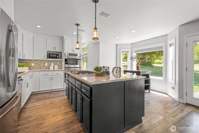 28314 164th Ave E, Graham, WA 98338 - kitchen featuring stainless steel appliances, white cabinets, recessed lighting, a center island, and backsplash