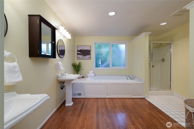 2650 W Newton St, Seattle, WA 98199 - bathroom featuring a bath, a shower stall, wood finished floors, and recessed lighting