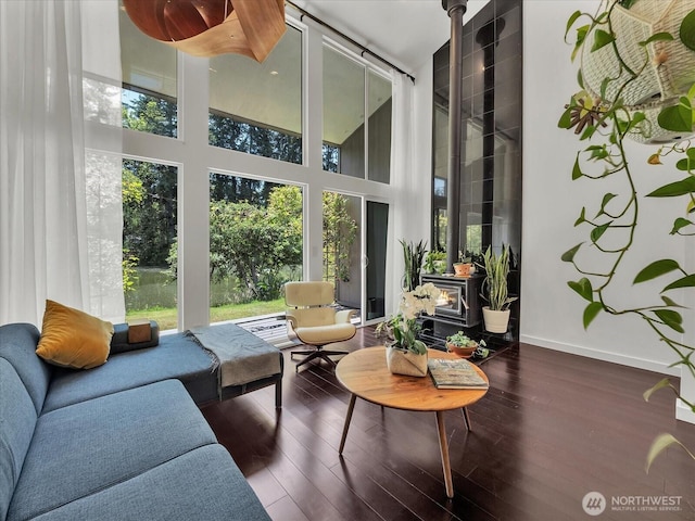 13893 NE 69th St Unit 689, Redmond, WA 98052 - living area with a high ceiling, healthy amount of natural light, a wood stove, and wood finished floors